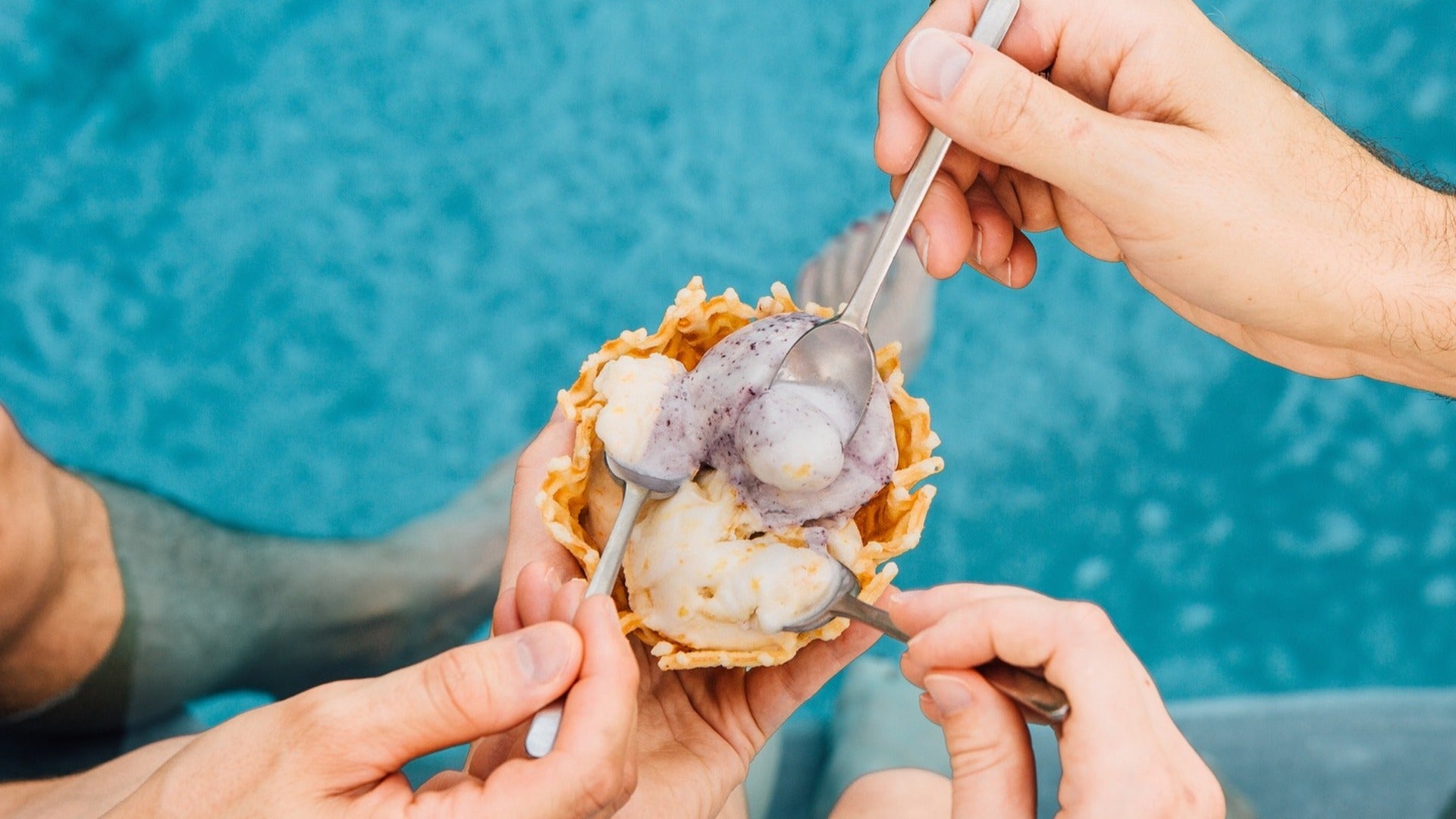 people sharing ice cream in a cone with a spoon