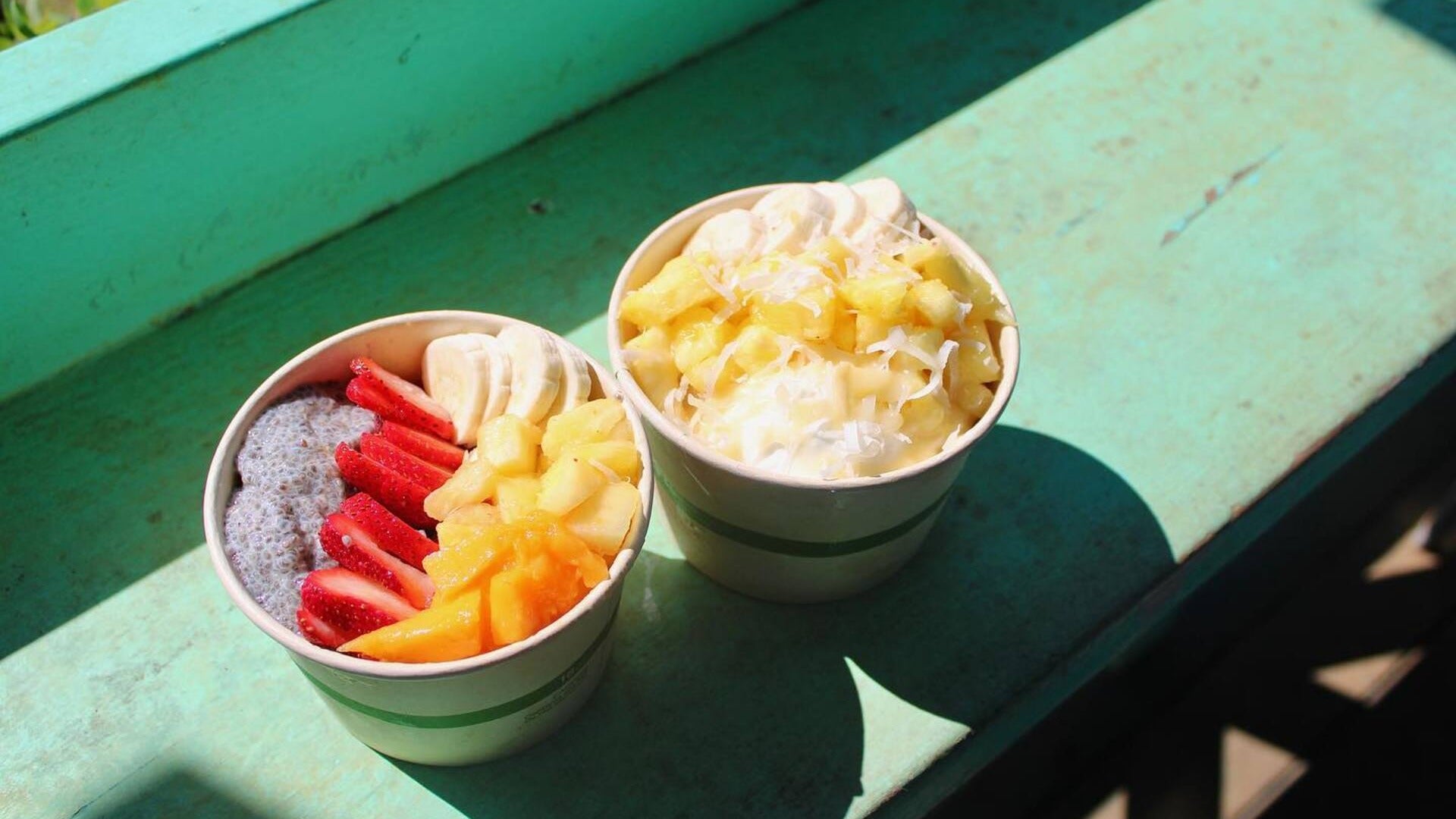 shaved ice with fruit toppings in a cup