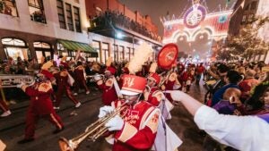 band in a parade, mardi gras, crowds of people watching