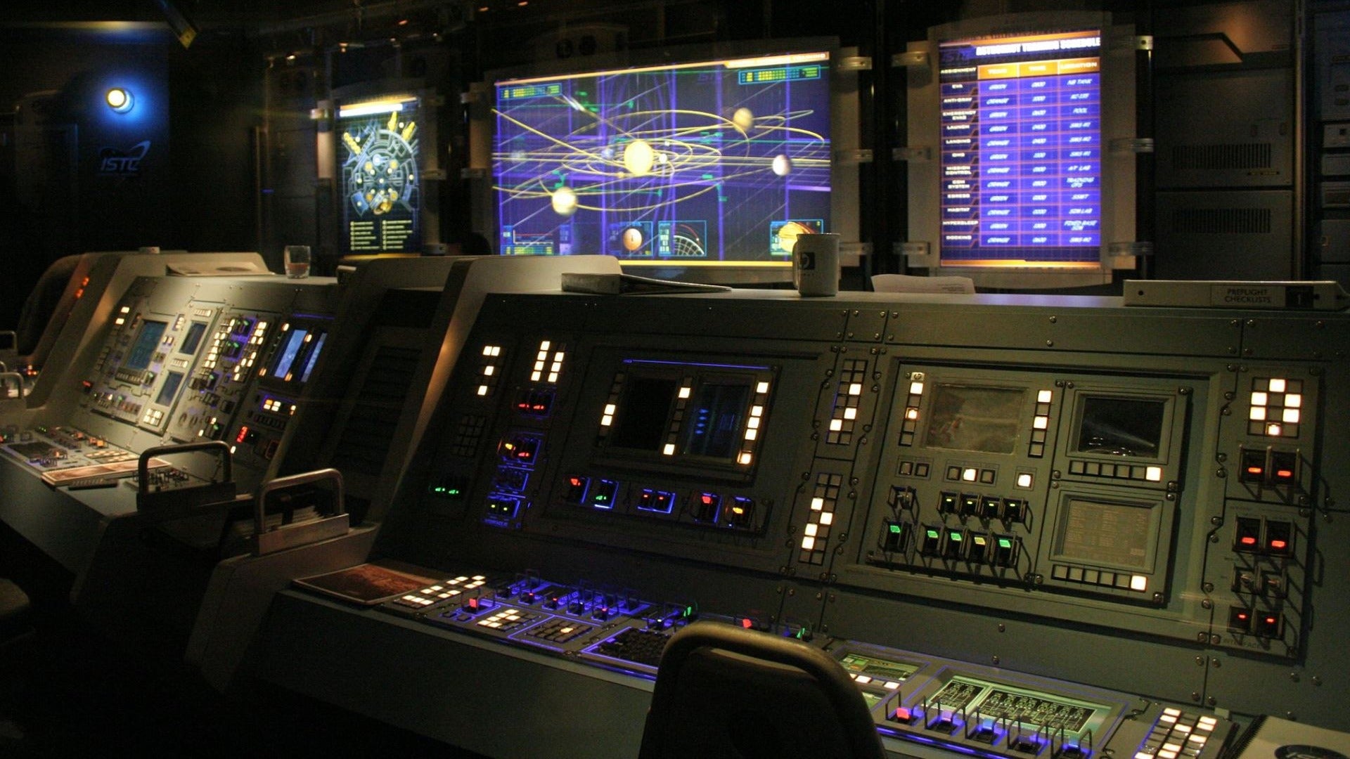 control center for a ride in disneyland with buttons and chairs