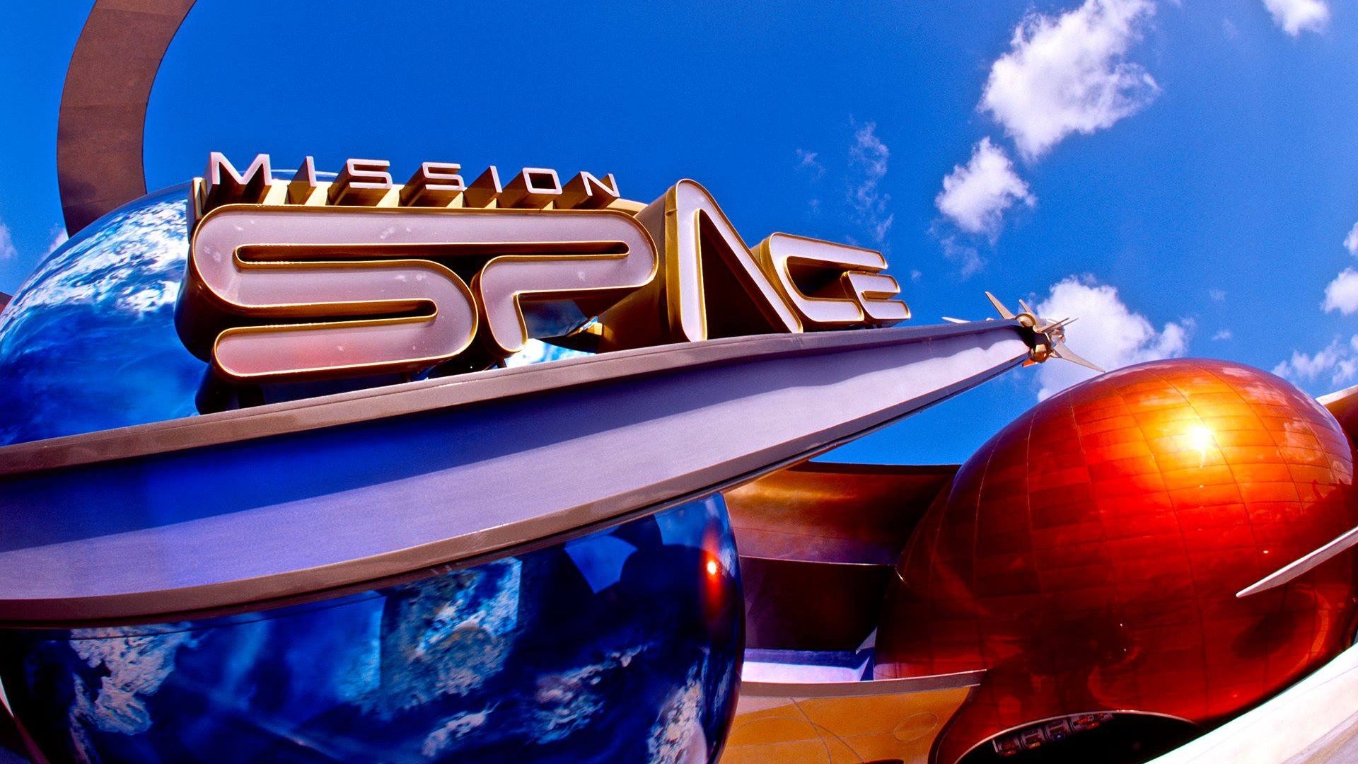 signage for a ride in disneyland with spaceship and planet