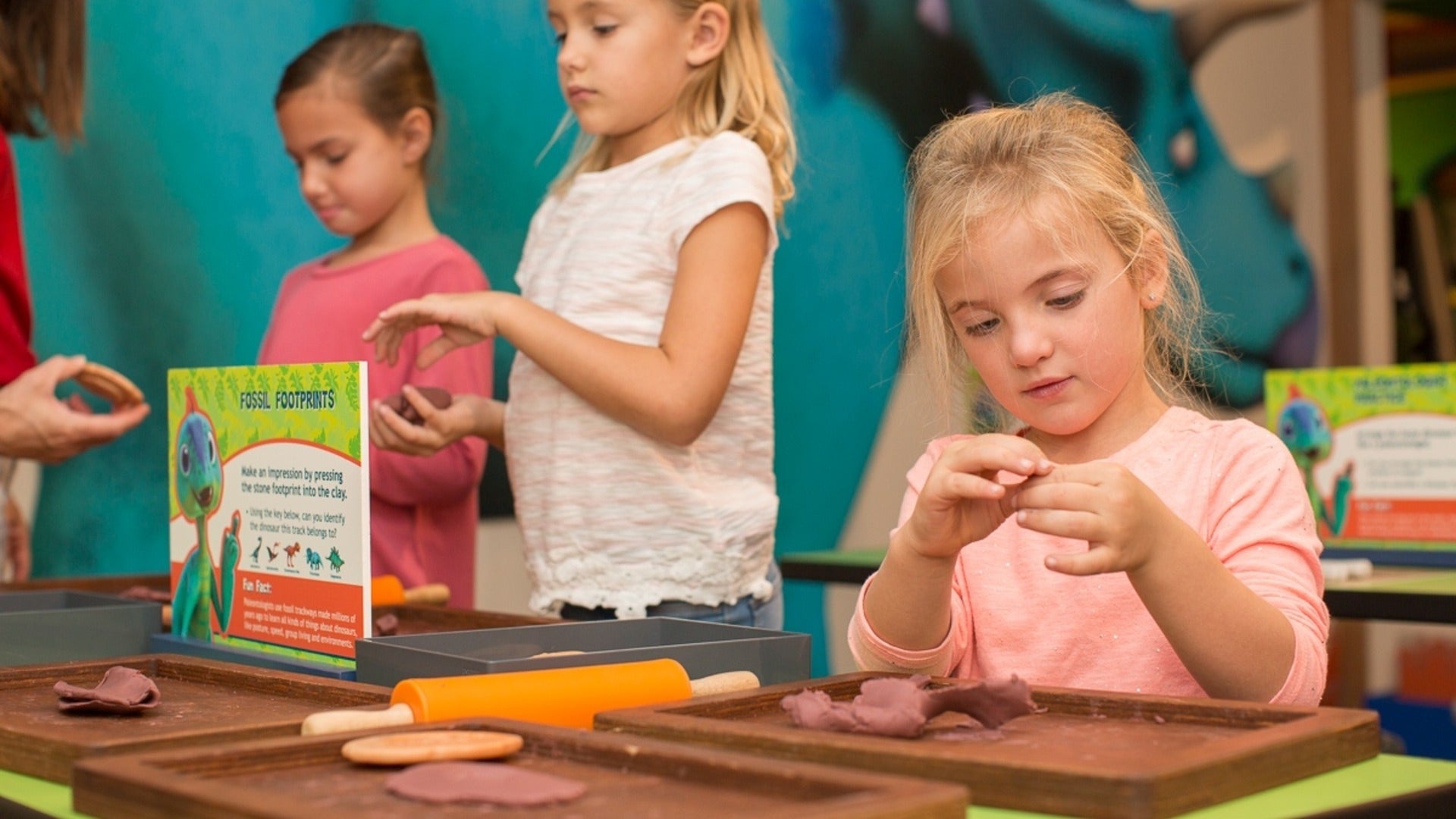 kids playing with clay in a museum