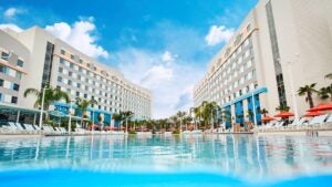 pool view with two buildings and trees