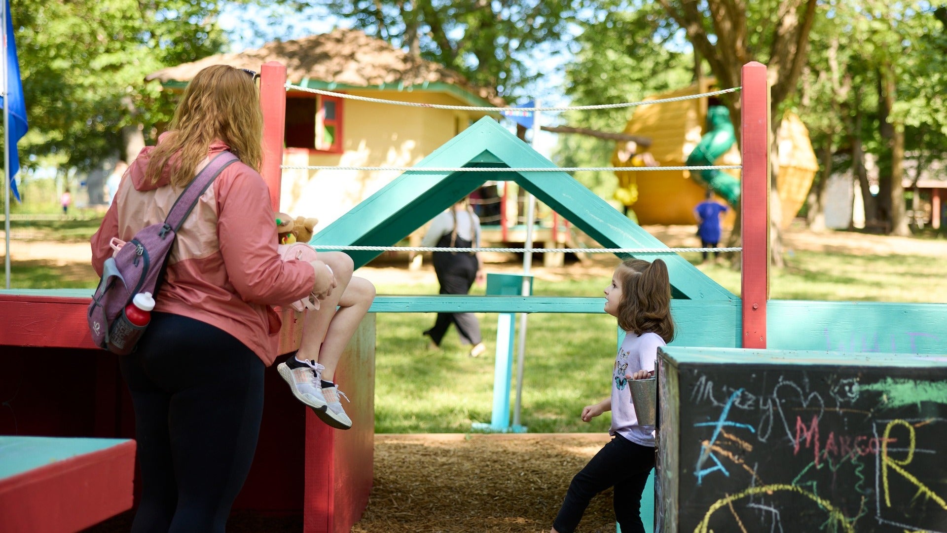 children playing in a play area inside a park