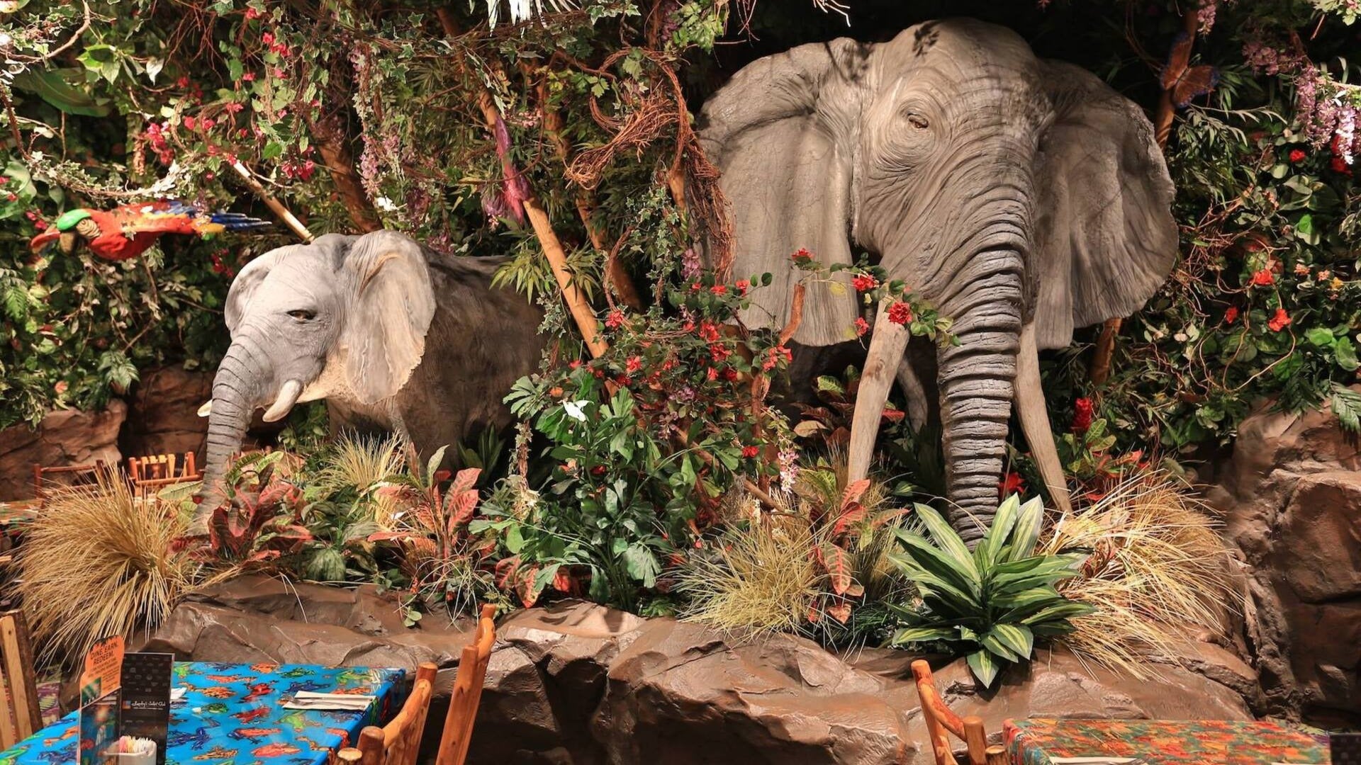 animal animatronics in a restaurant with plants and dinner tables