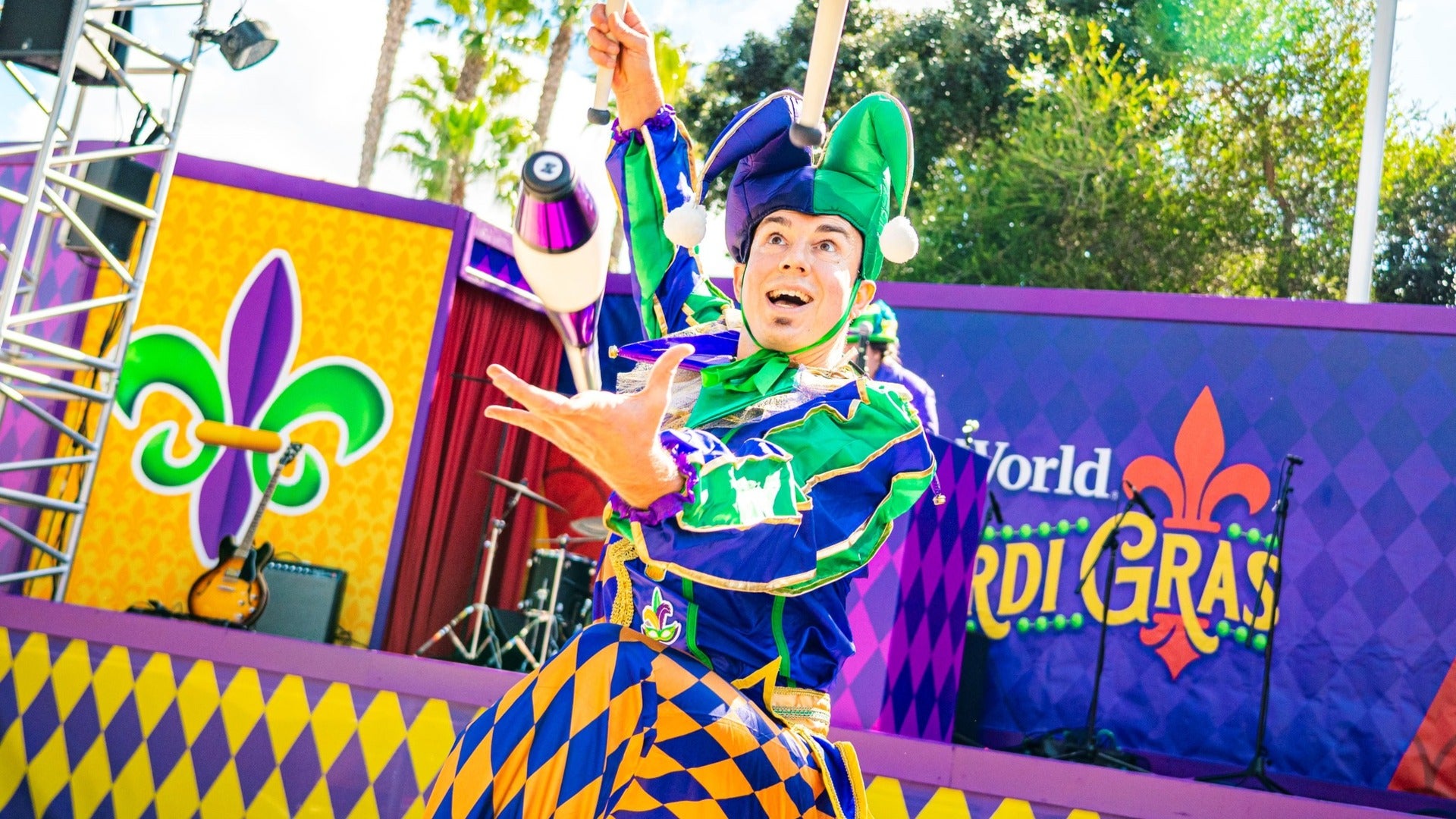 juggler with stage at the back, mardi gras