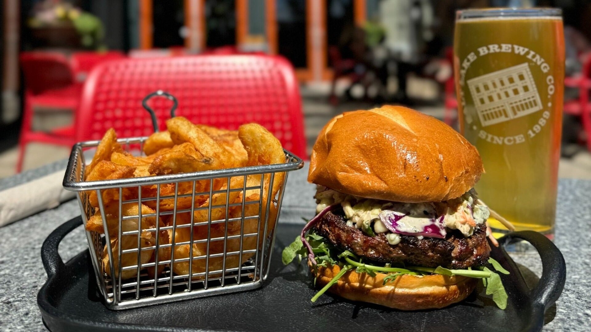 burger served with fries and beer on the side