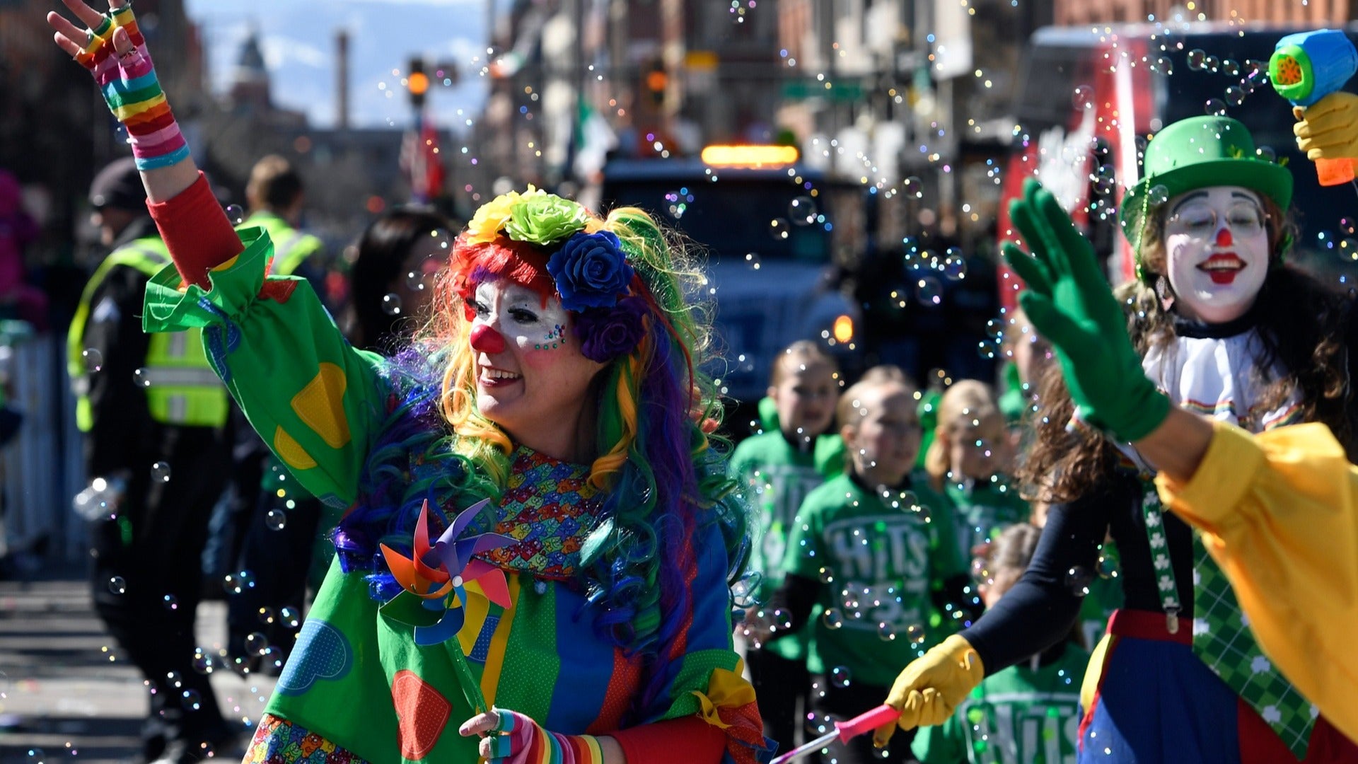 clowns and people in costume walking a parade during st patricks day