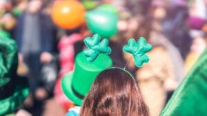 child wearing a three leaf clover headband