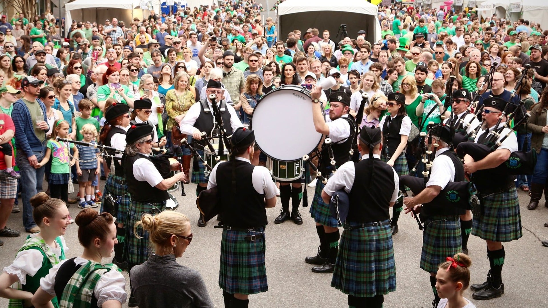 group of irish performers with a crowd watching them