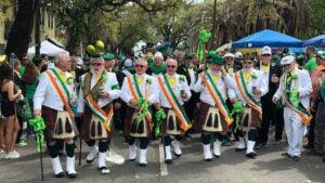 people in irish wear at a parade for st patricks day