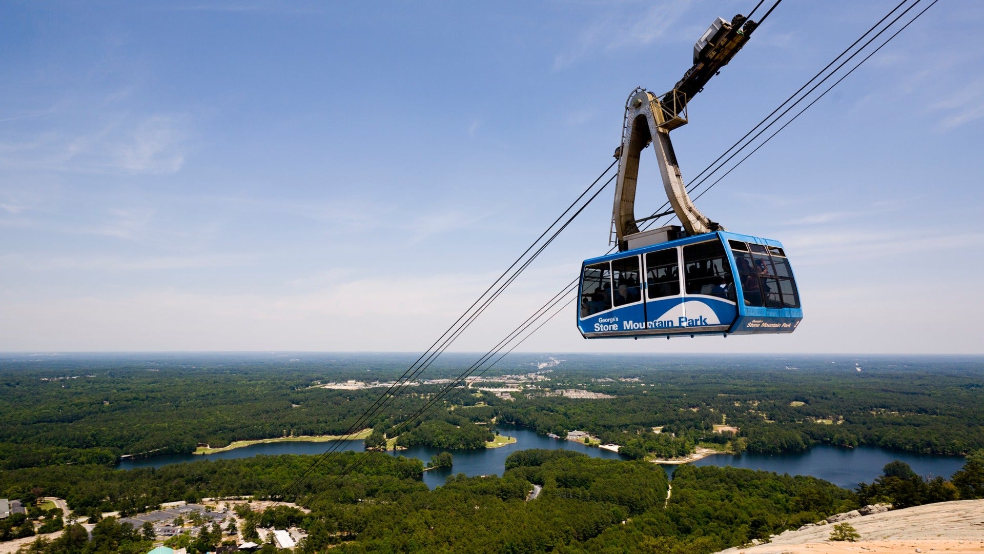 cable car with a view of trees and river