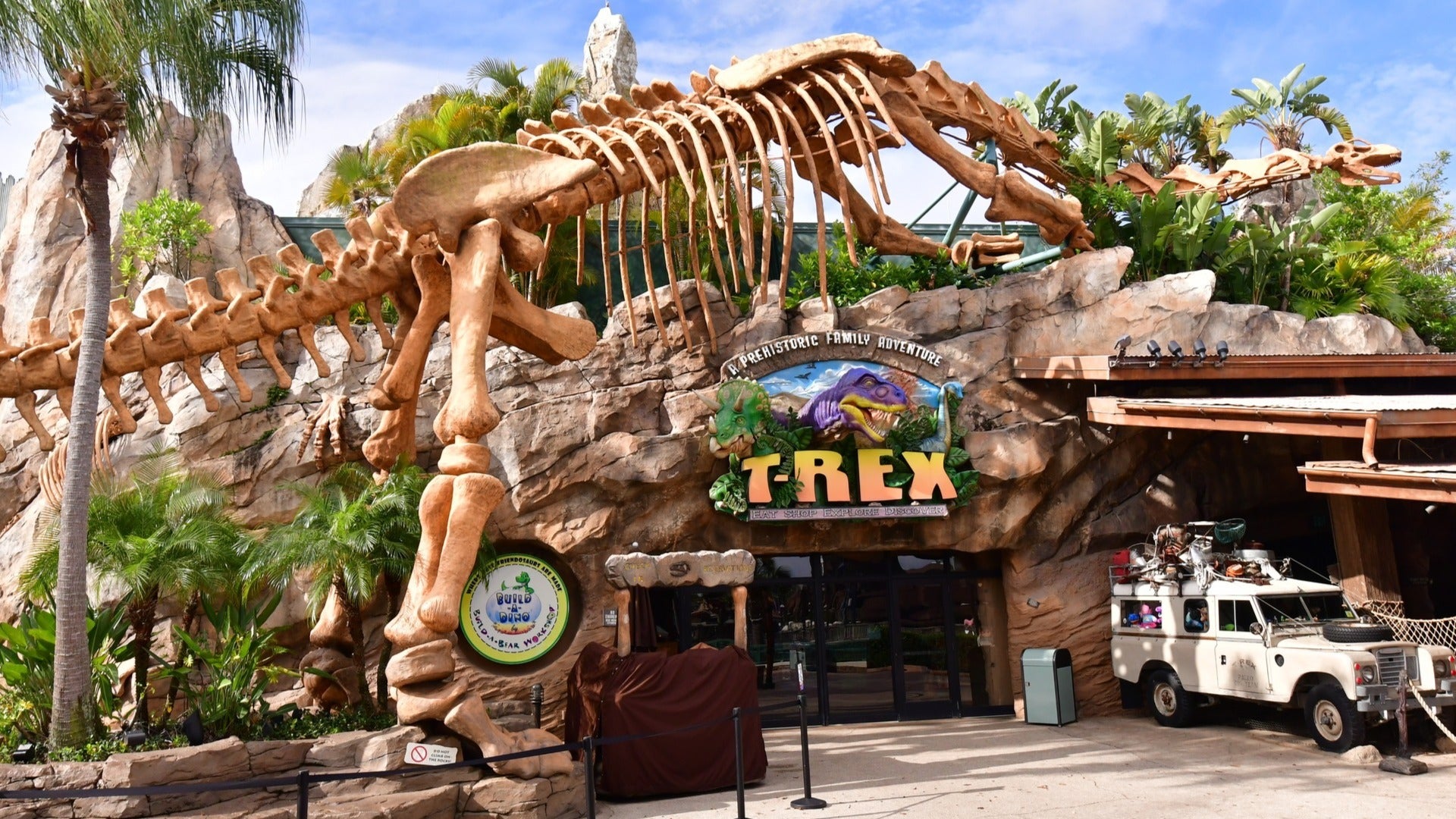 cafe with large dinosaur display and vehicle at the side