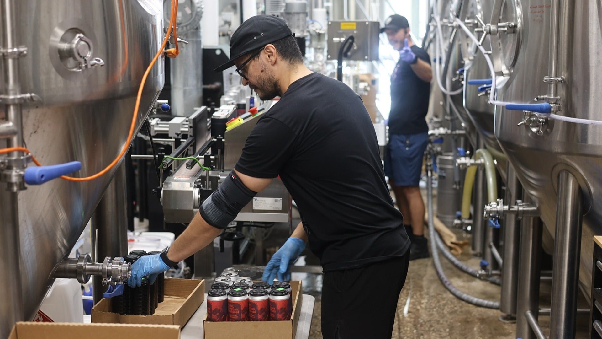 men pouring out beer in a facility