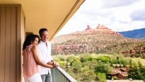 couple overlooking arizona red rocks on a balcony