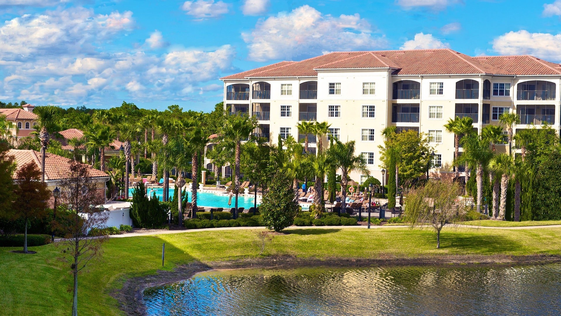 hotel with pool in front and trees