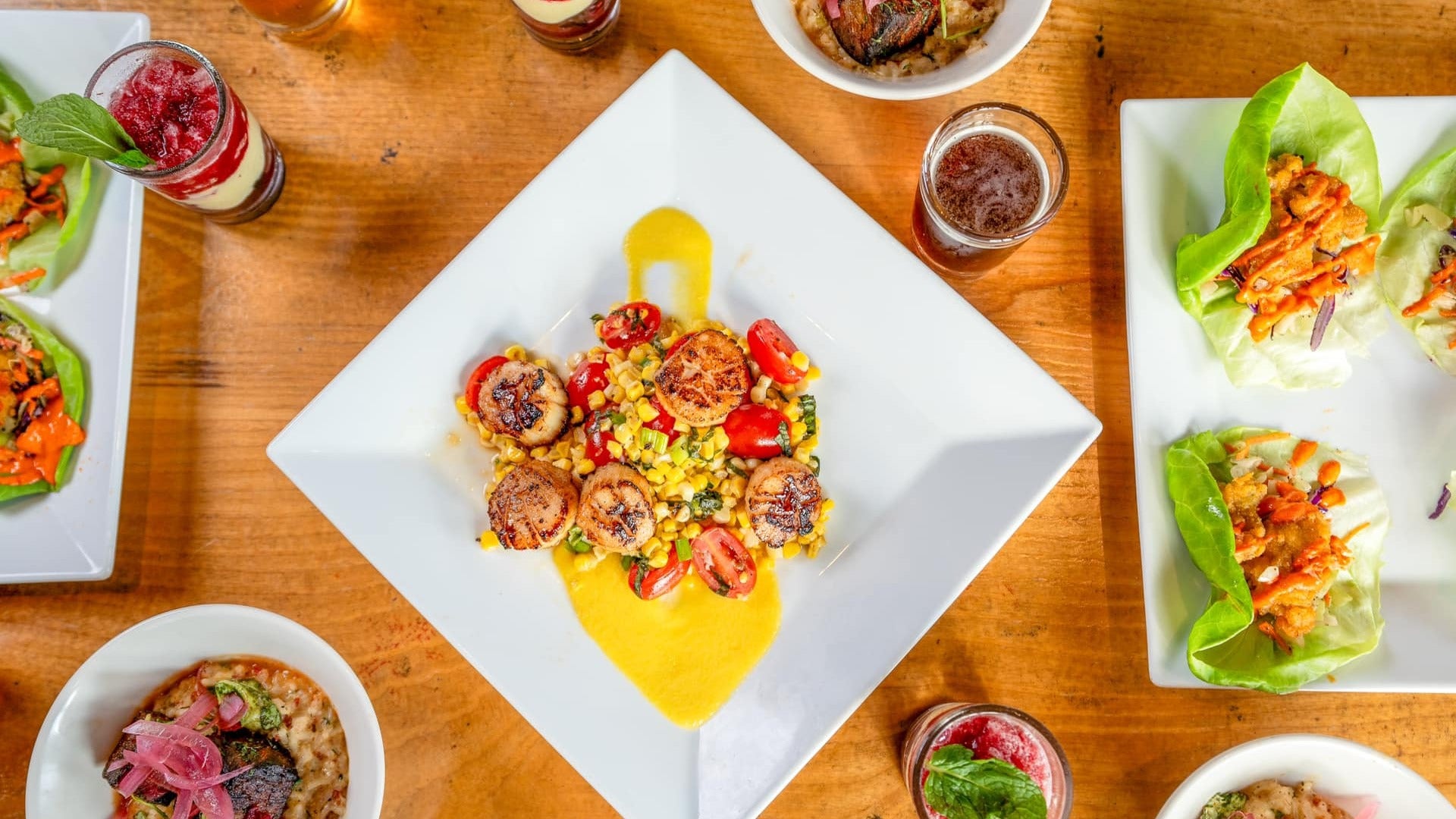 different sets of food served with drinks on a table