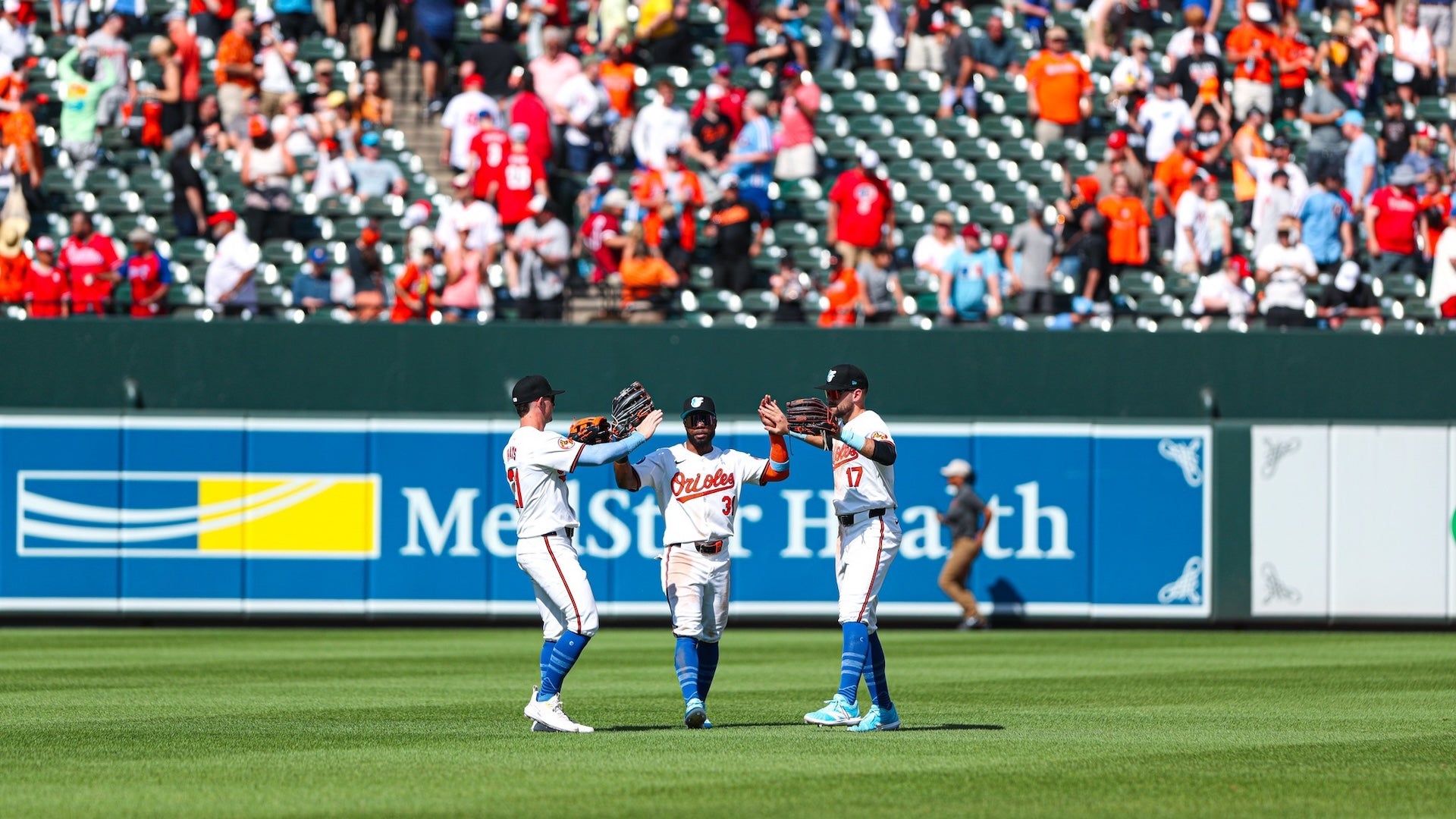 three baseball players in the field