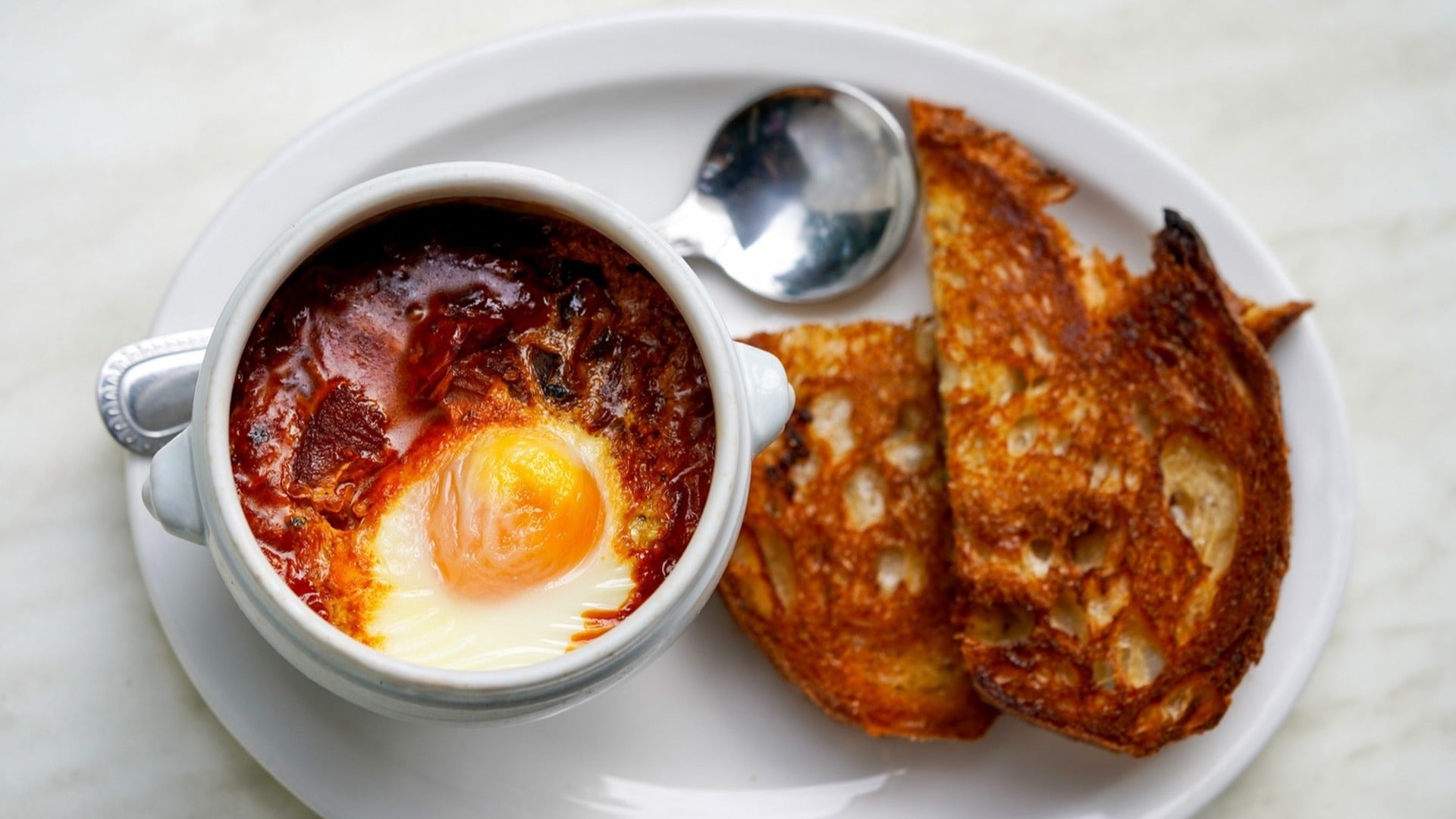 shakshuka with toast and a spoon