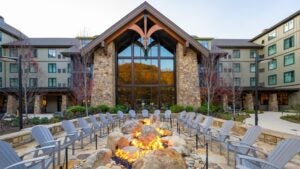 hotel exterior with bonfire pit and chairs surrounding it