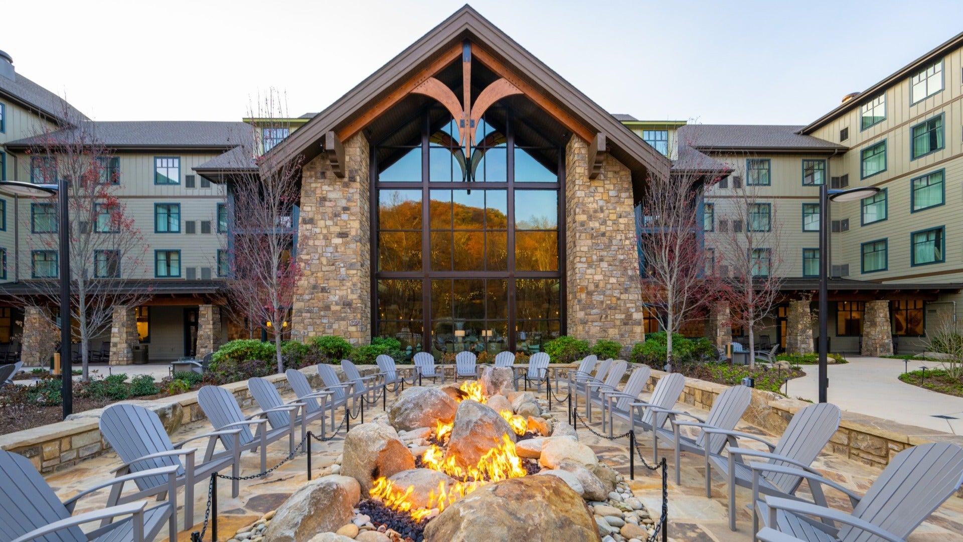 hotel exterior with bonfire pit and chairs surrounding it