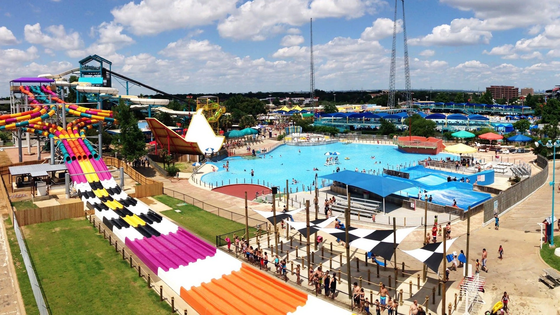 theme park with pool, slides, and people