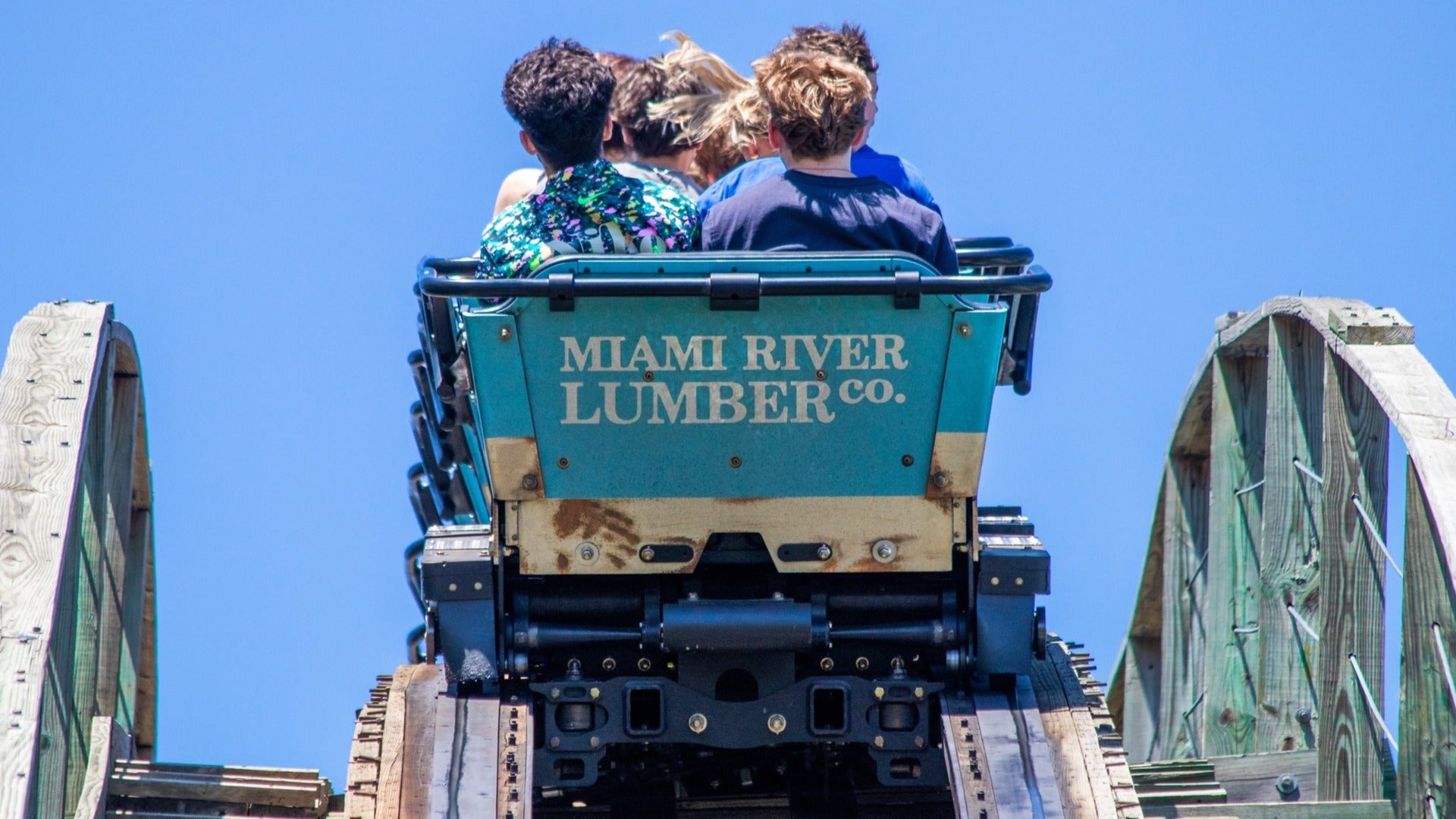 wooden roller coaster with people on it