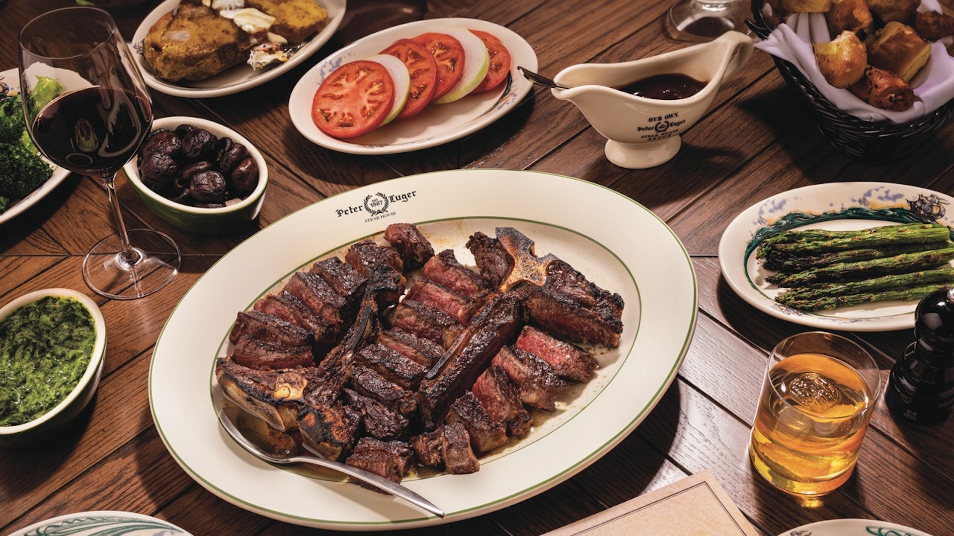 a plate with sliced steak pieces surrounding with side dishes