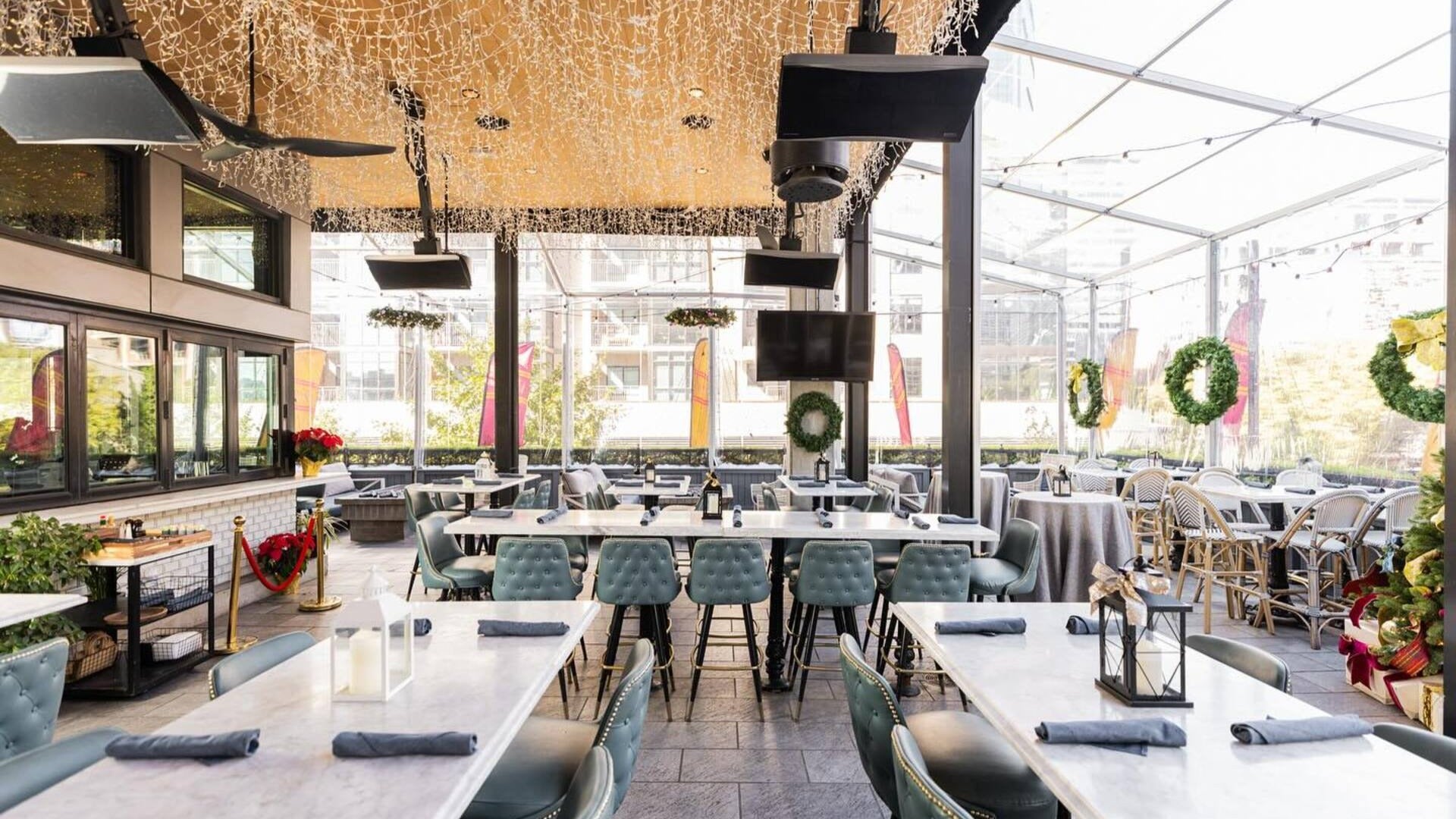 rooftop bar with string lights, tables, chairs