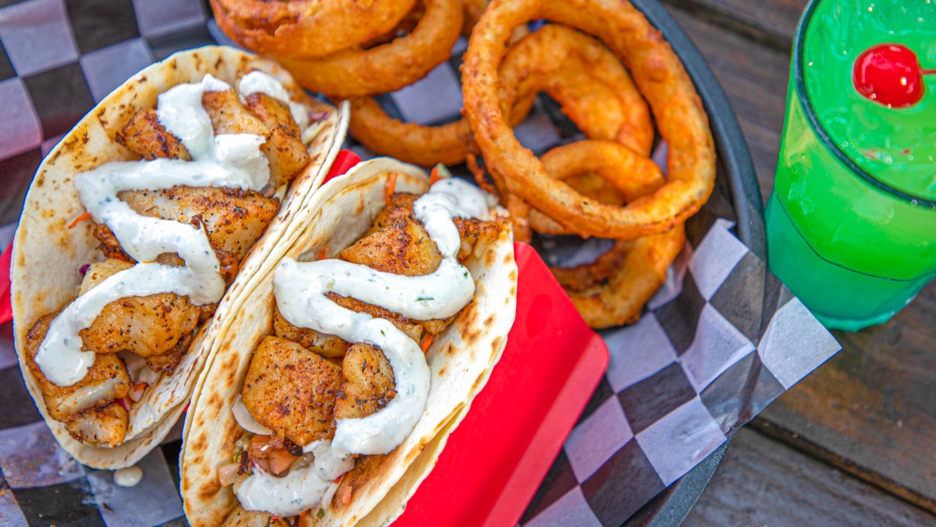 tacos with onion rings and juice on the side