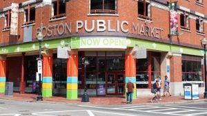 public market with people walking on the sidewalk