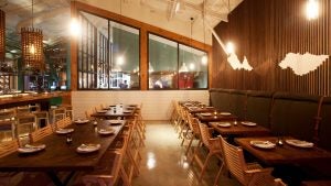 restaurant interior with tables, chairs, plates and lamps