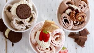 different ice cream flavors in cups with toppings