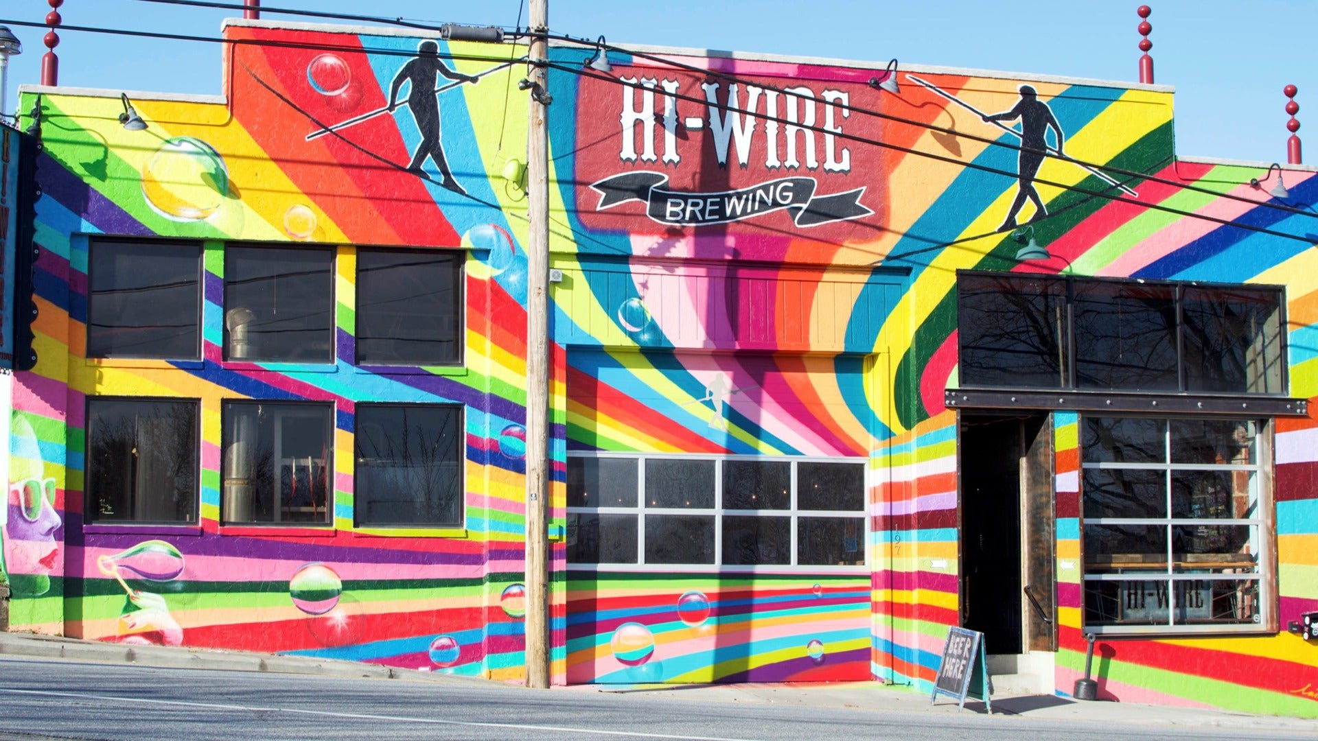 colorful building with cable wires and signage in front