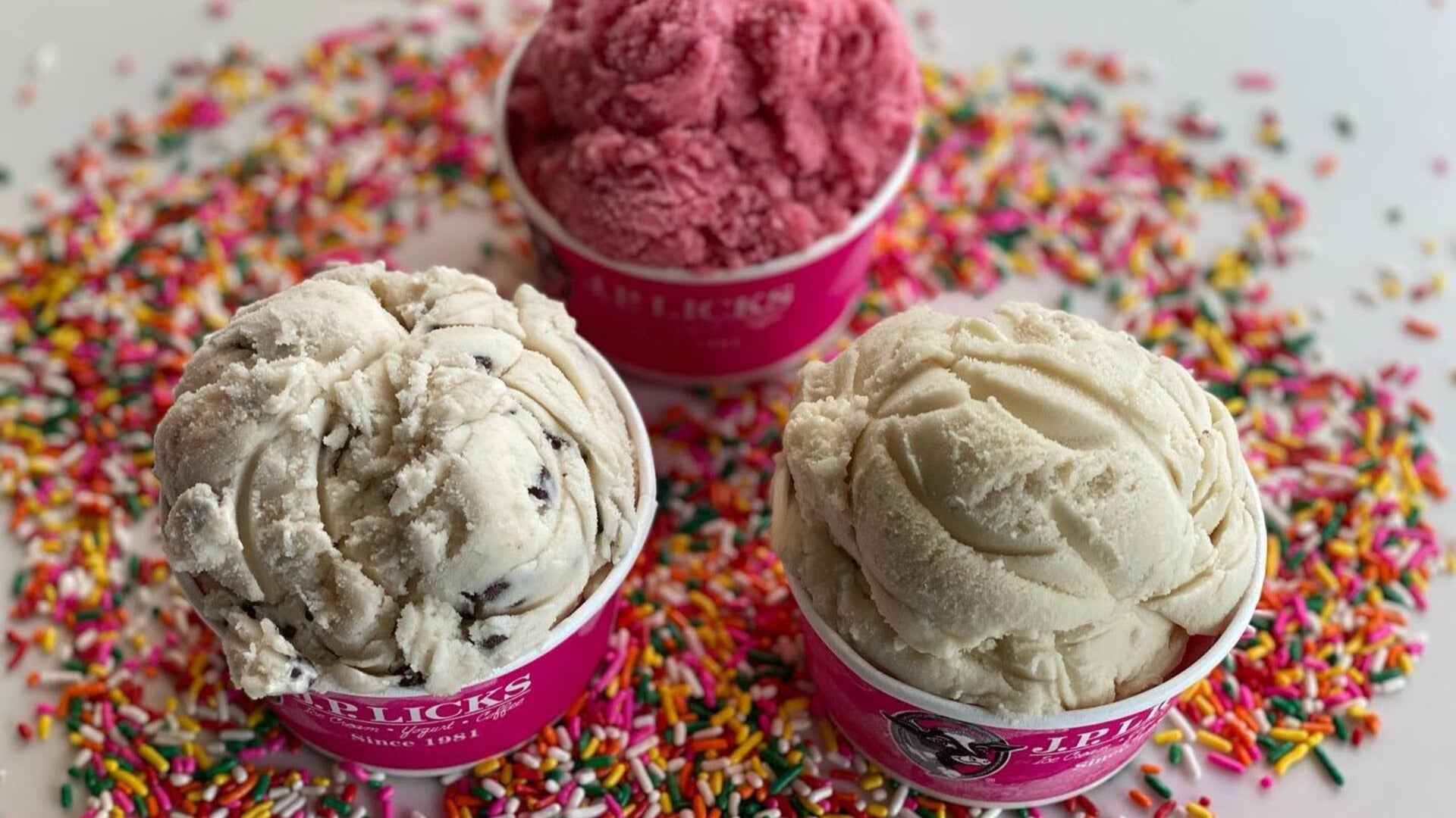 different ice cream flavors in cups with sprinkles