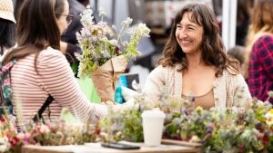 woman selling flowers to a customer