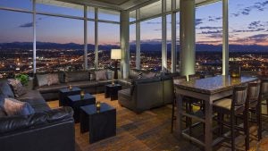 rooftop restaurant and bar with view of denver skyline, tables and chairs