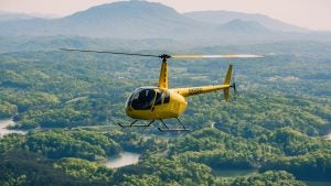 helicopter flying over smoky mountains