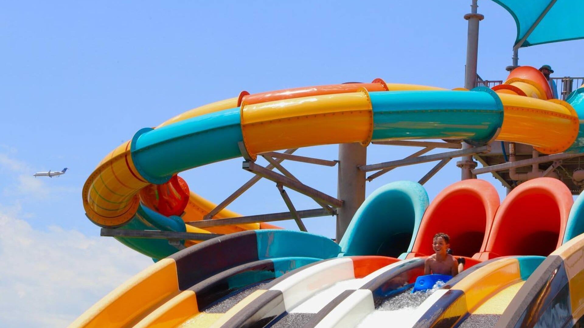 water slide with a boy going down on it