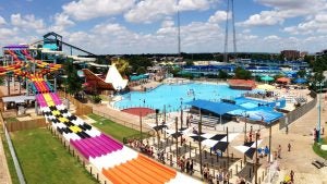 waterpark with slides and pool and people enjoying in it