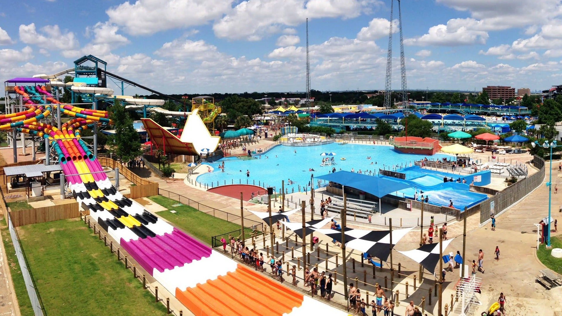 waterpark with slides and pool and people enjoying in it