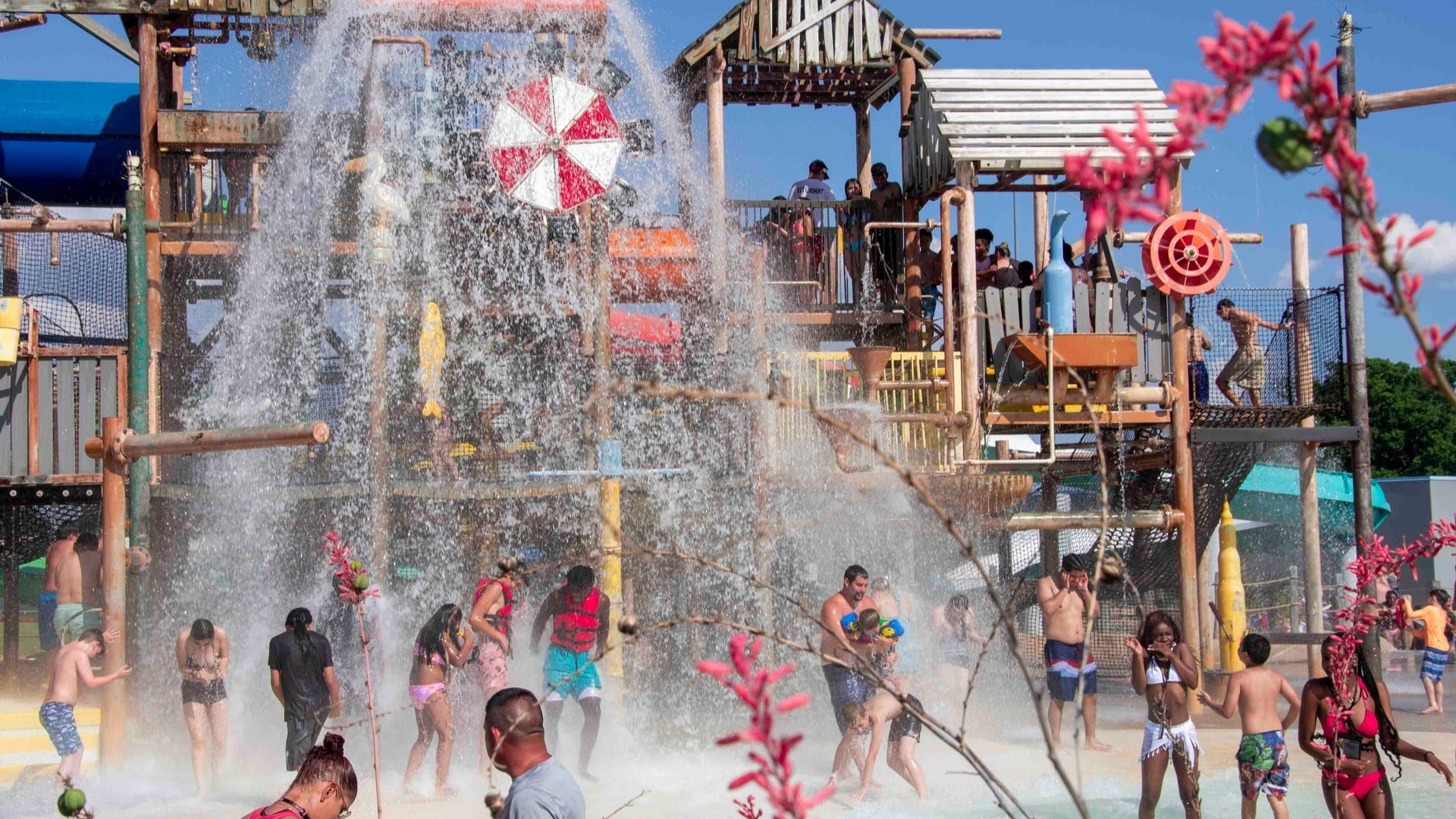 people enjoying a waterpark with slides and pools