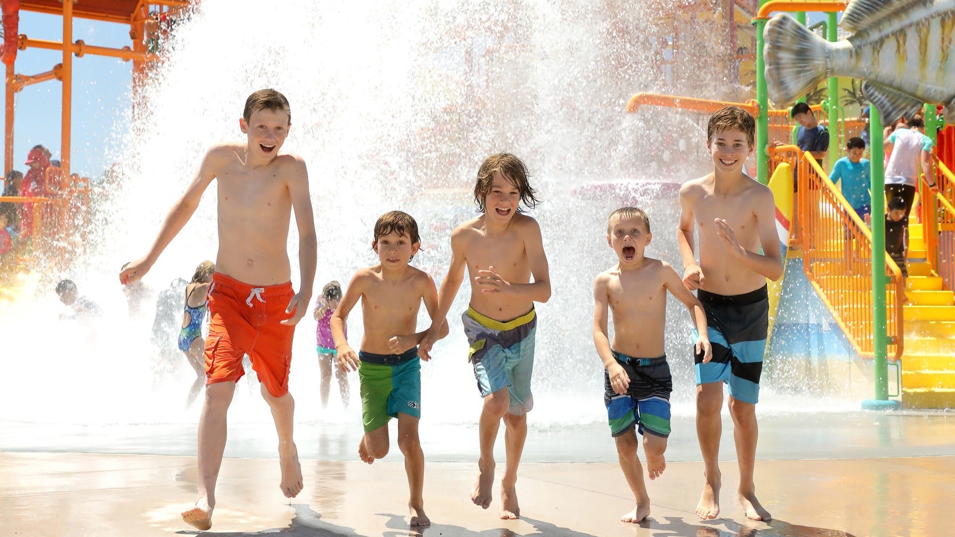 kids running in a waterpark splash pad