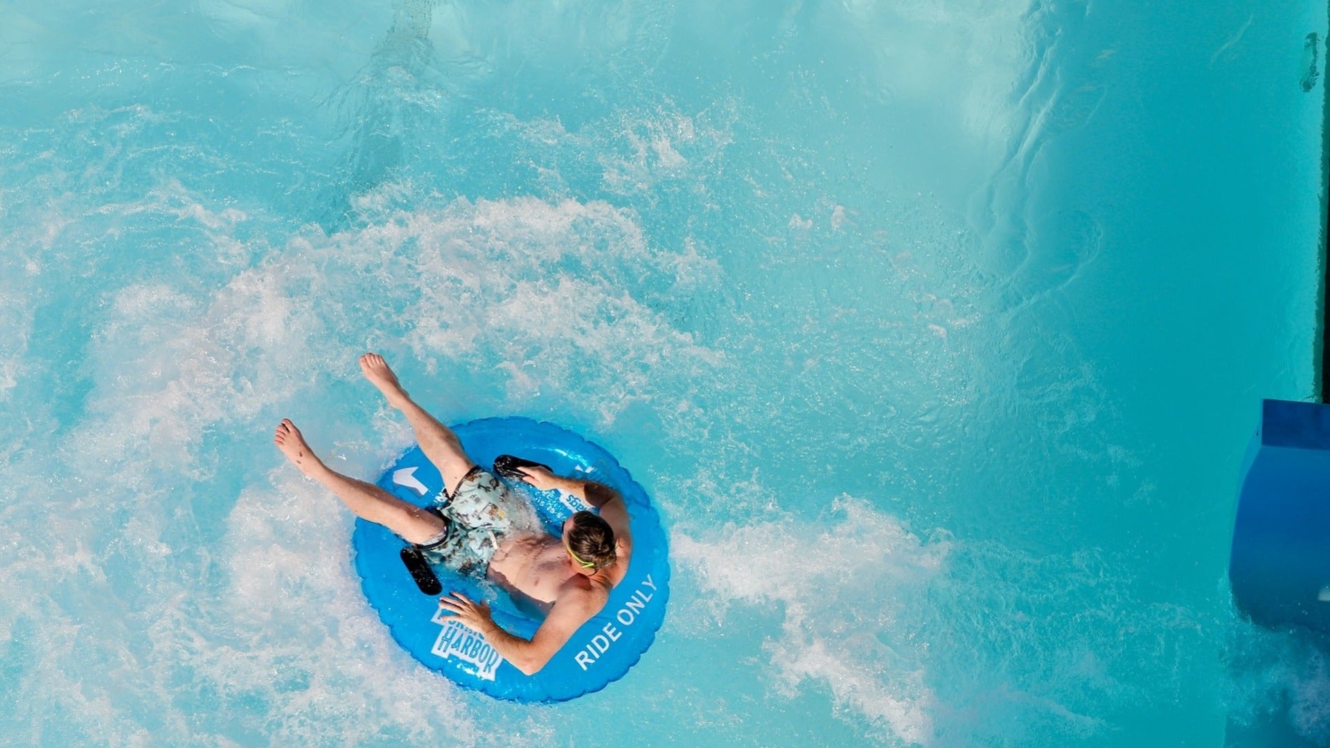 boy in a floatie in a pool