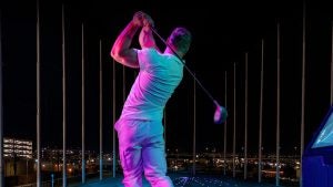 man golfing at night