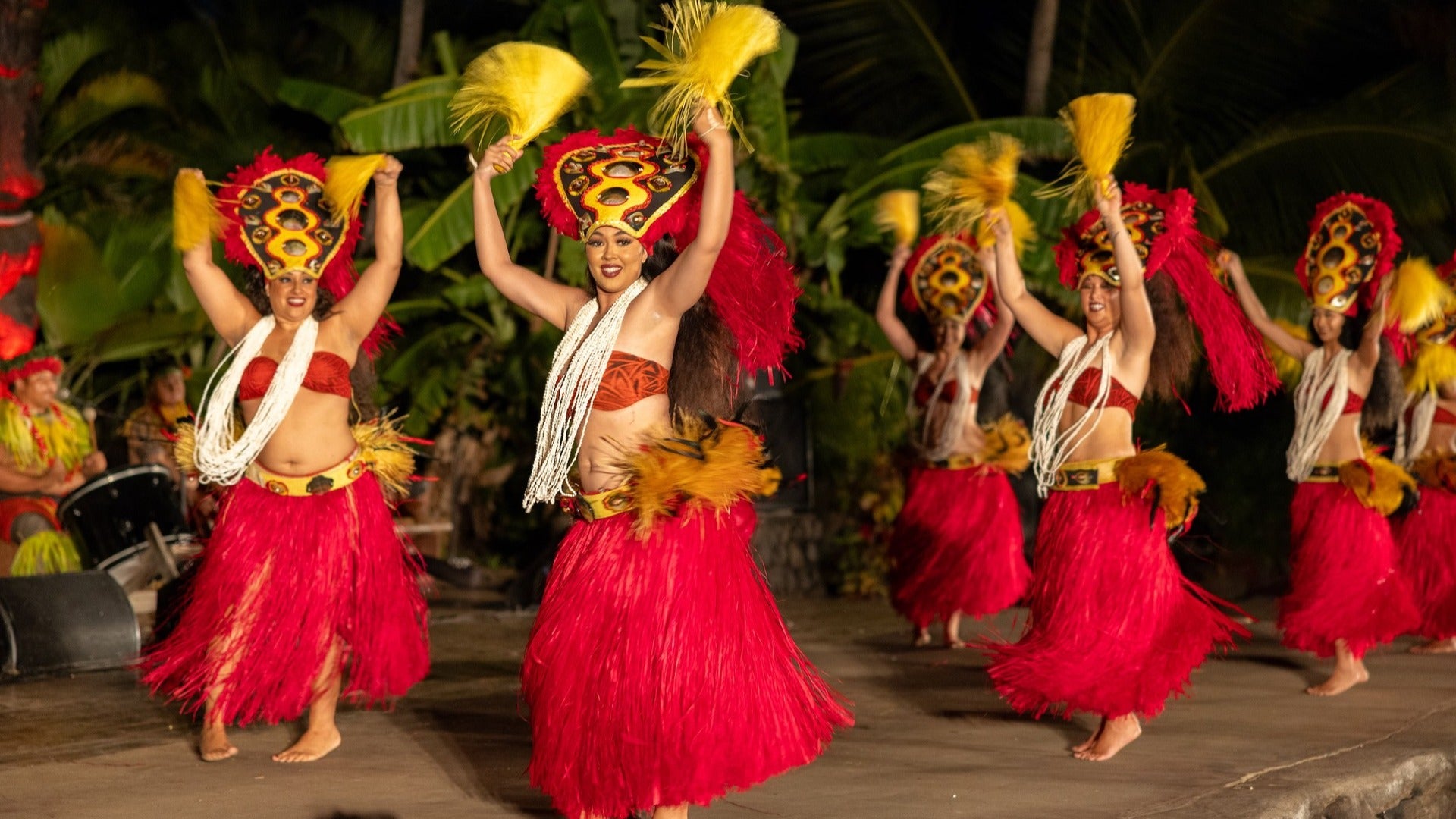 women in luau outfits performing