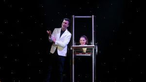 magic performer on stage with assistant