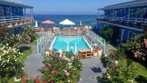hotel with pool and string lights and garden overlooking the sea