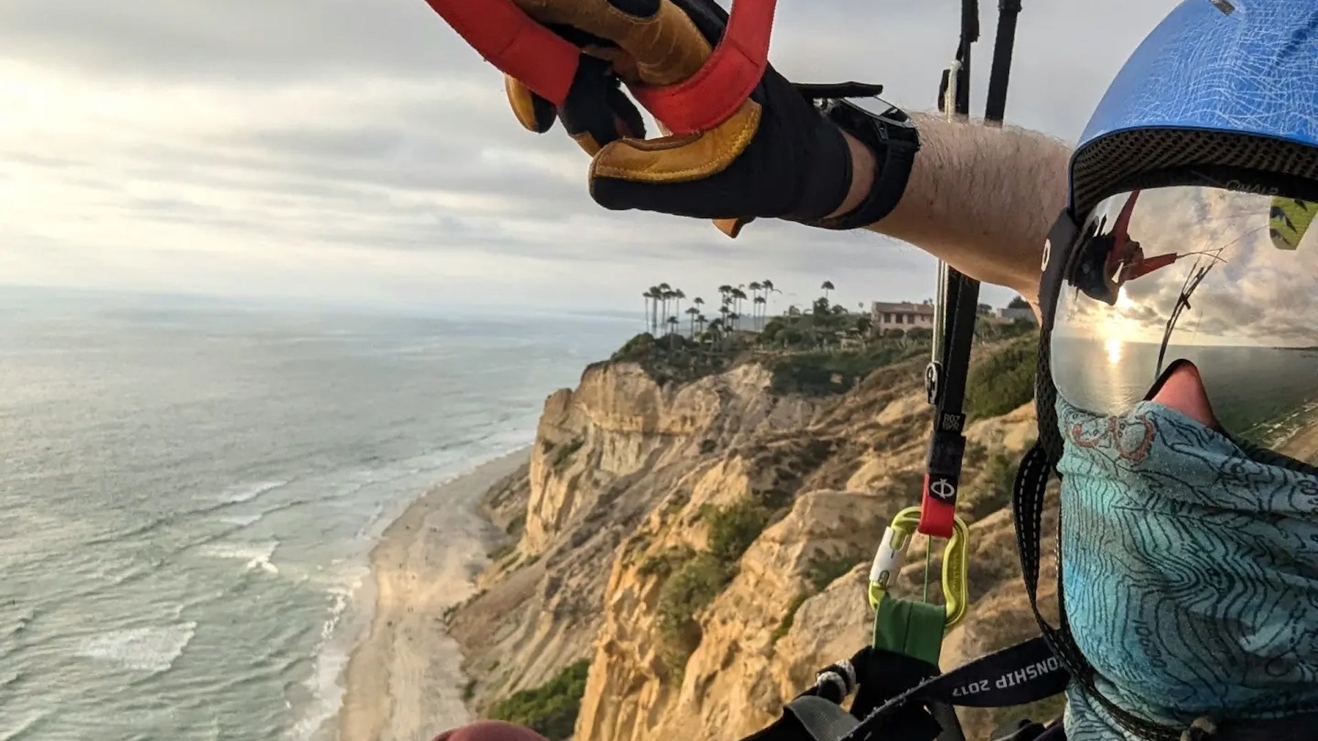 a man's taking photo while paragliding