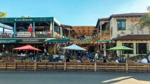 cafe with people dining in it, cafe umbrellas and outdoor dining